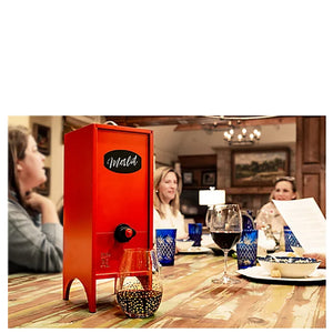 Red wine tasting beverage dispenser on kitchen table with women gathered